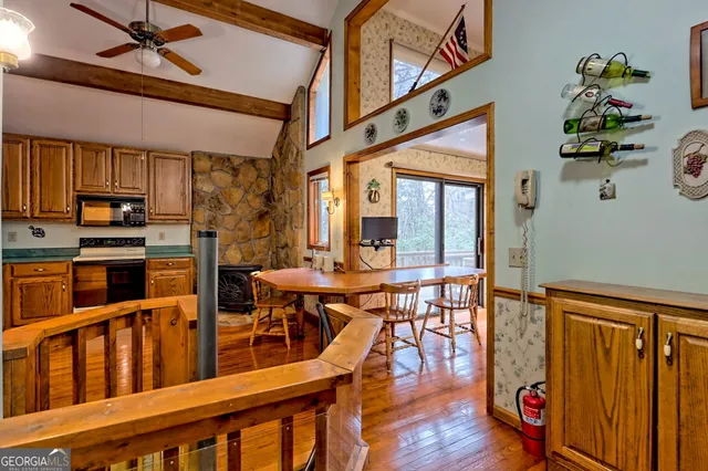 a view of a room with wooden floor and fan