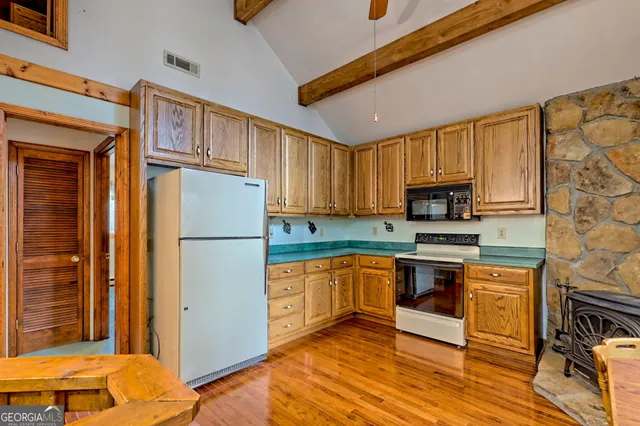 a view of a balcony with chairs and wooden floor