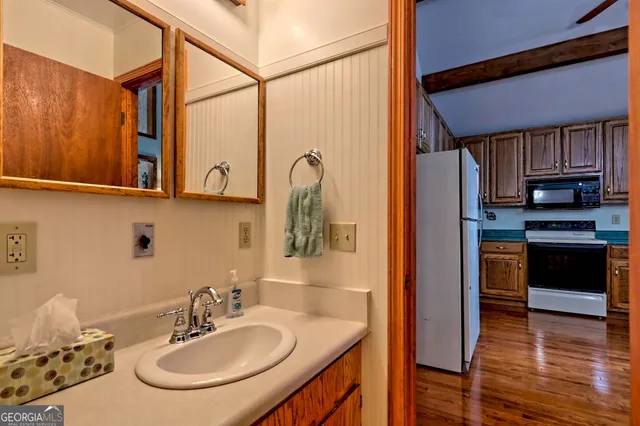 a view of a balcony with wooden floor and fence
