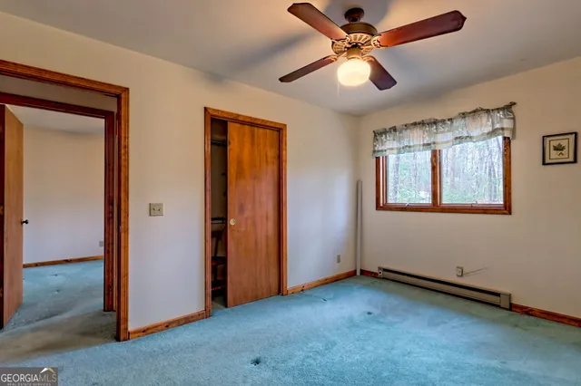 a view of a hallway with dining room and wooden floor