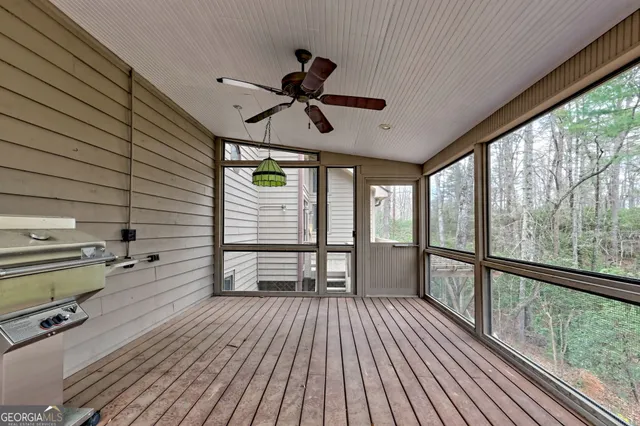 a view of a house with a yard and large trees