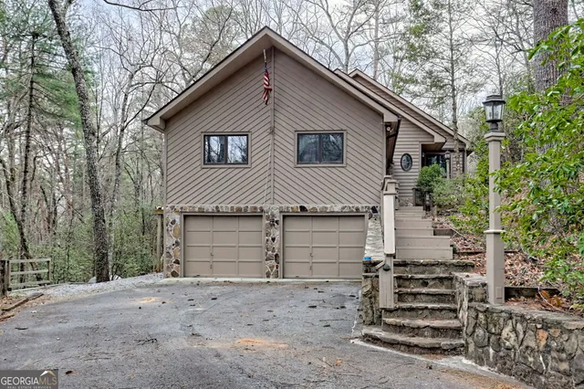 a view of a house with a yard and garage