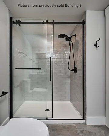 a bathroom with a glass shower door