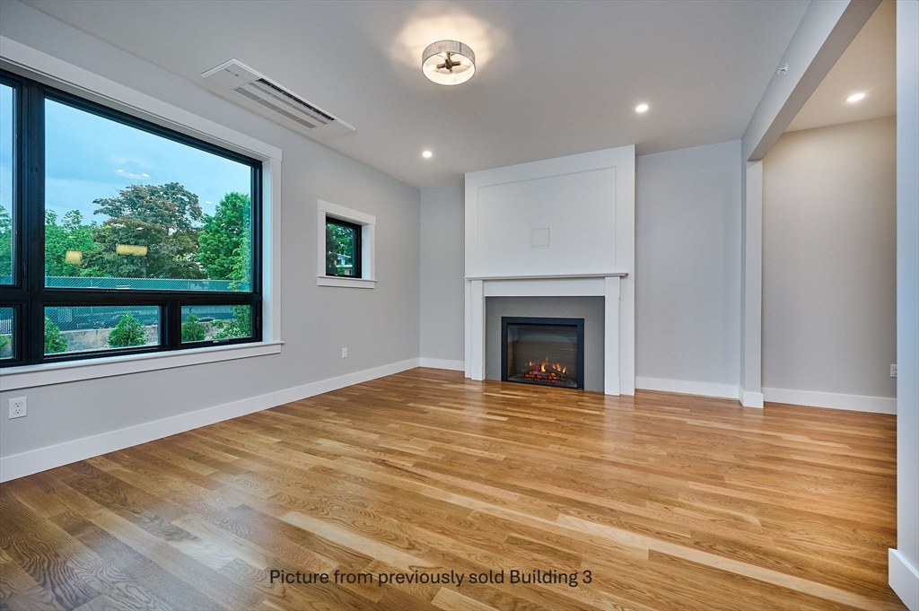 10 Hawley Street, Unit 4A Northampton, MA 01060 - Photo 3 of 25 a view of an empty room with wooden floor and a window