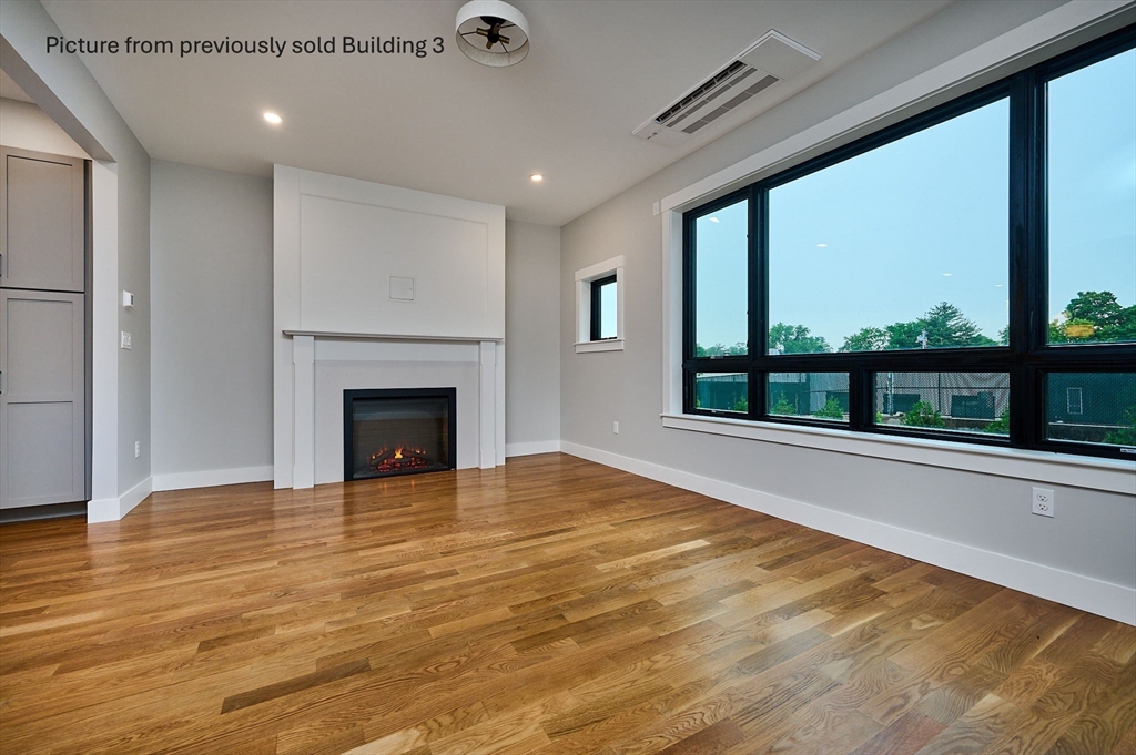 10 Hawley Street, Unit 4A Northampton, MA 01060 - Photo 6 of 25 a view of an empty room with a fireplace and a floor to ceiling window