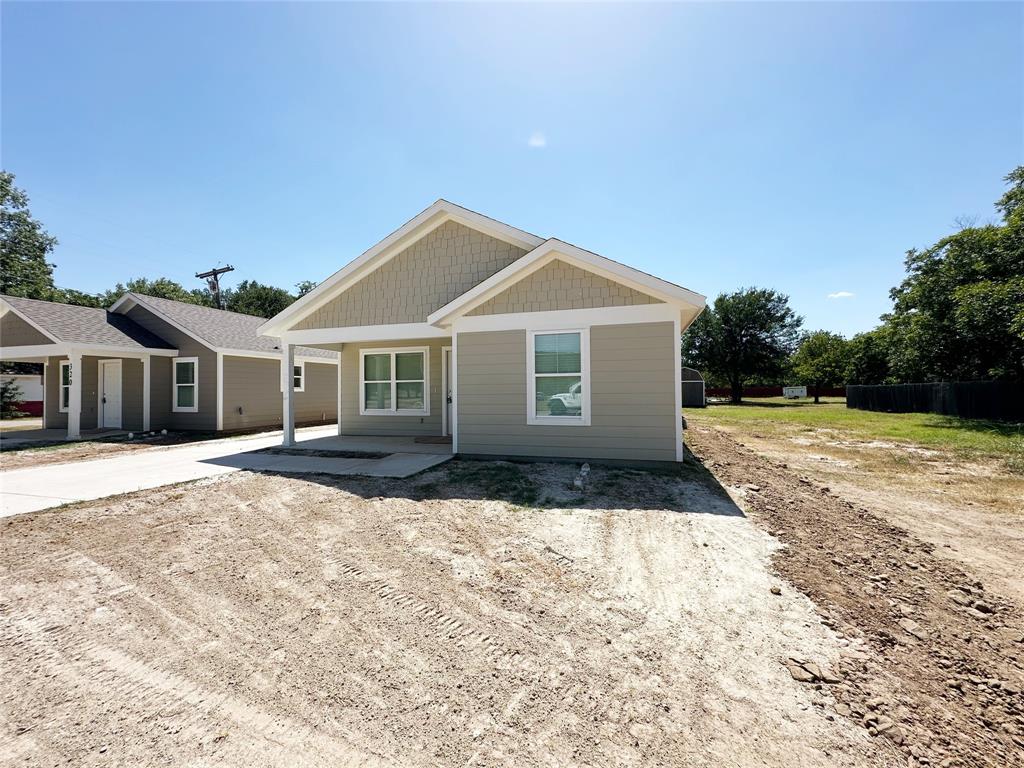 318 Southwest 14th Street Mineral Wells, TX 76067 - Photo 1 of 1 a front view of a house with a yard