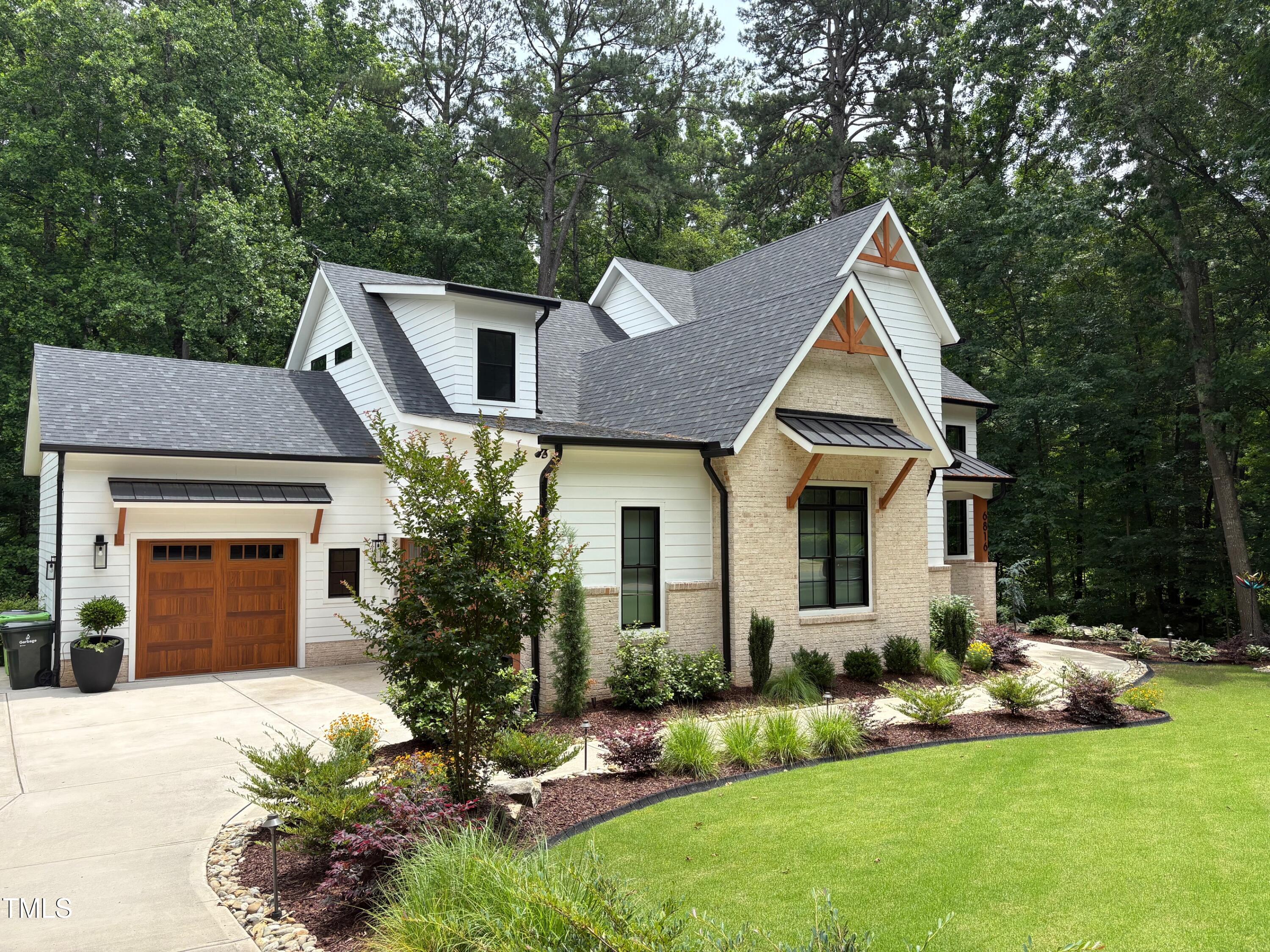 6816 Rainwater Road Raleigh, NC 27615 - Photo 2 of 66 a front view of a house with a yard and garage