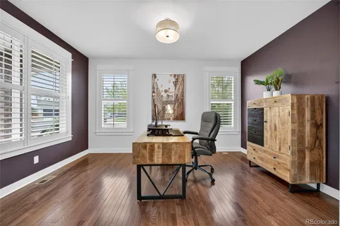 a view of a workspace with furniture and a window
