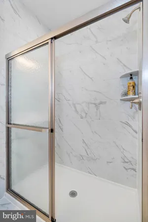 a bathroom with a glass shower door