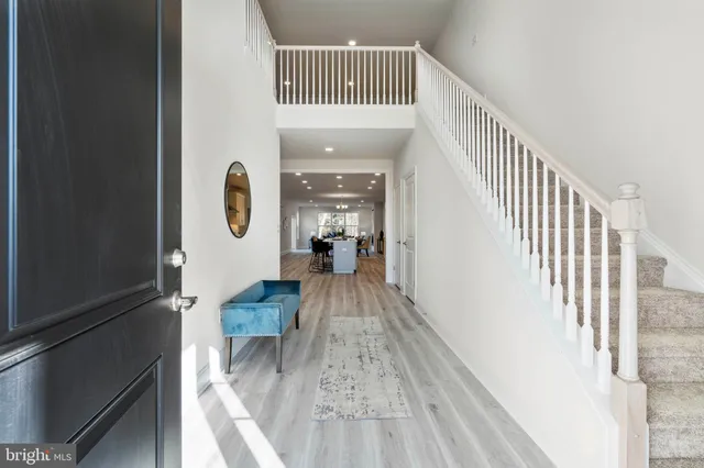 a view of a hallway with wooden floor and dining room