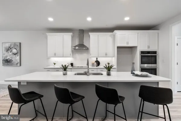 a kitchen with granite countertop a sink and white appliances
