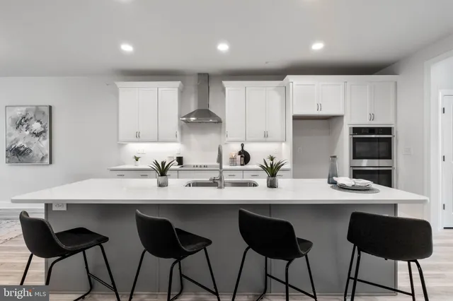 a kitchen with granite countertop a sink and white appliances