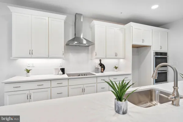 a kitchen with appliances a sink and cabinets