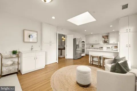 a spacious bedroom with a bed couch and a window