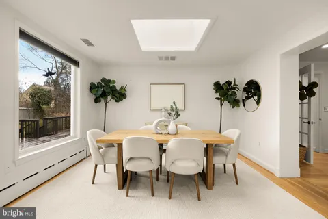 a bedroom with a large bed and a potted plant
