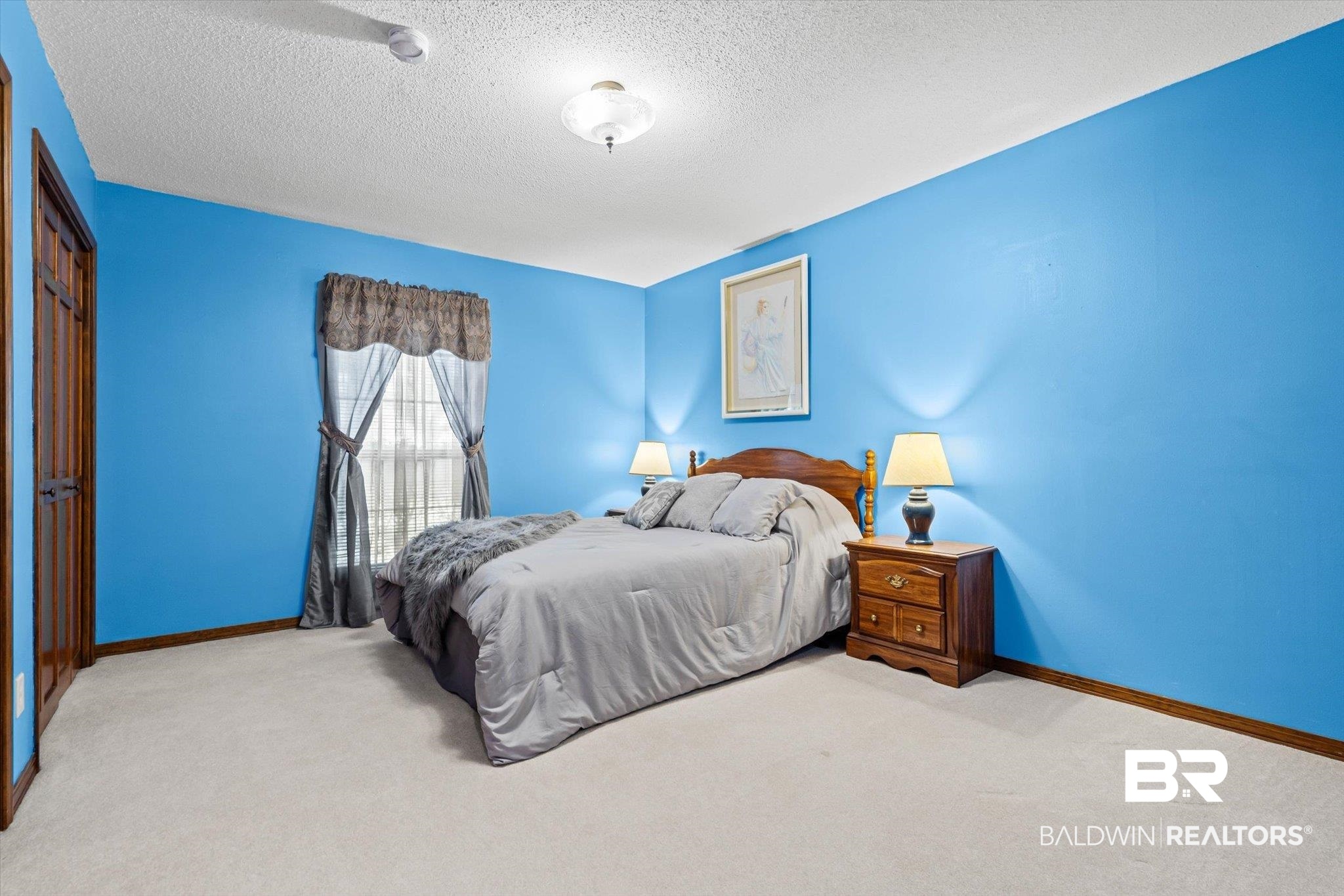 1900 Foxfire Road Mobile, AL 36618 - Photo 19 of 36 Bedroom featuring carpet floors, a textured ceiling, and a closet