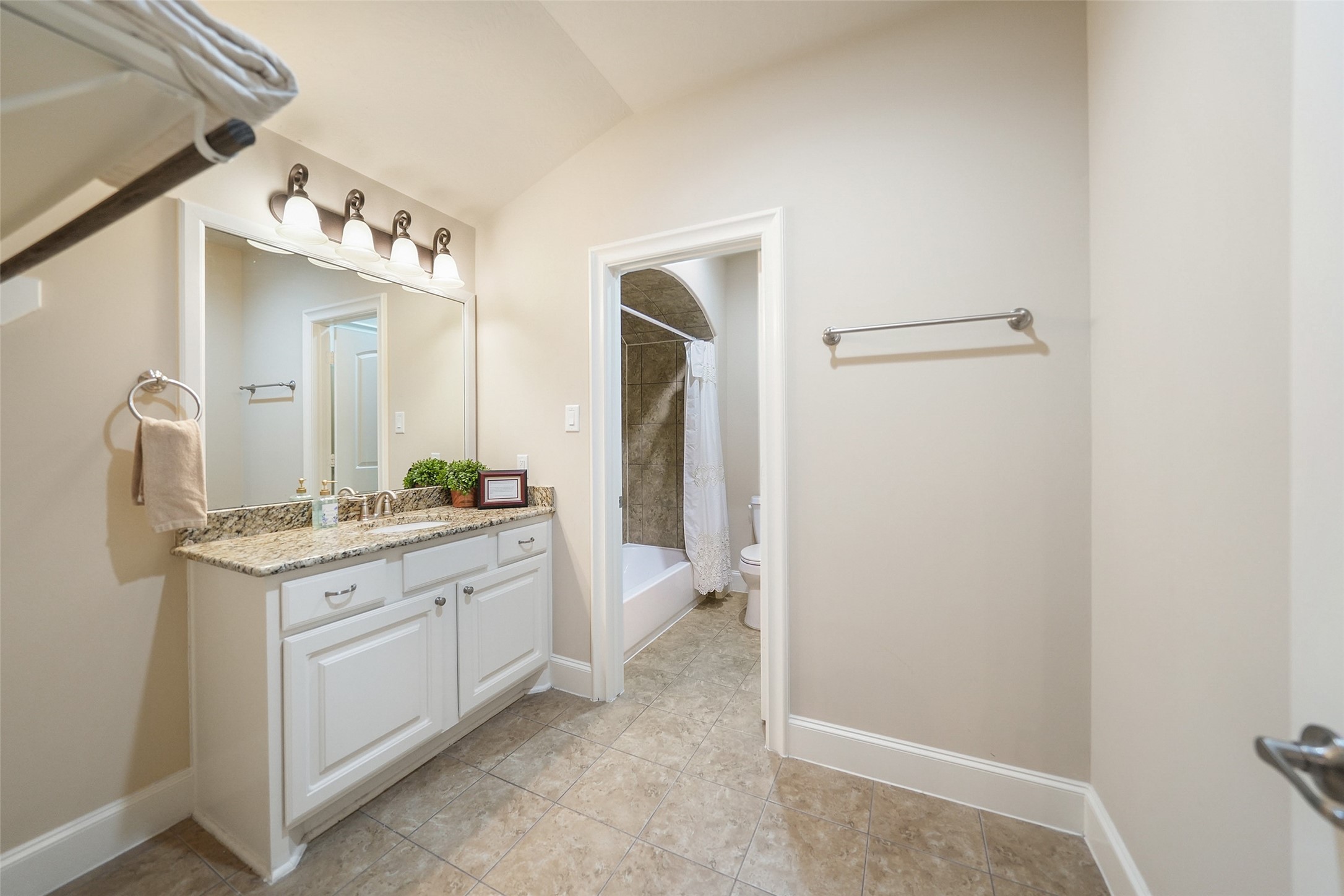 26250 A Riley Road Waller, TX 77484 - Photo 42 of 50 Upstairs bath with granite vanity and separate tub/shower area; retreat includes an ADA-compliant bathroom for accessibility.