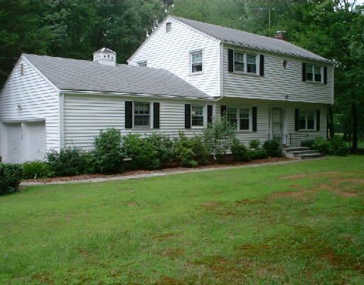 2370 High Ridge Road Stamford, CT 06903 - Photo 1 of 1 a front view of a house with a yard and green space
