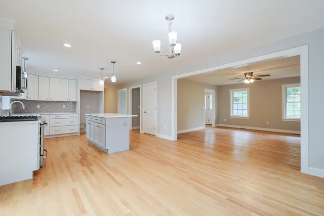 a view of kitchen with sink and refrigerator