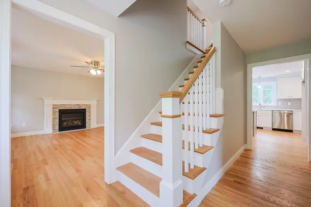 a view of a livingroom with wooden floor and stairs
