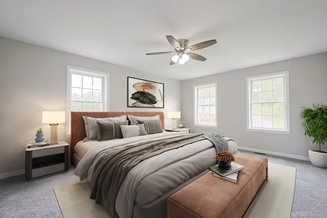 a bedroom with a bed couch and window