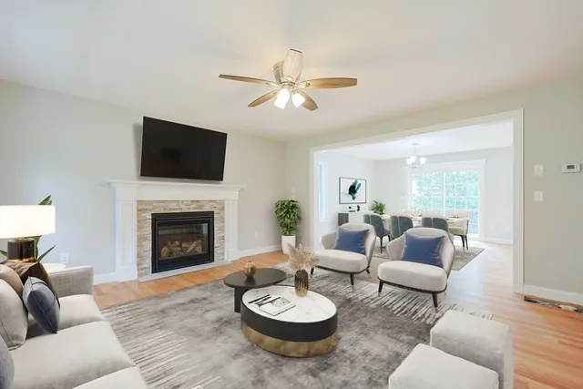 a living room with furniture a fireplace and a flat screen tv
