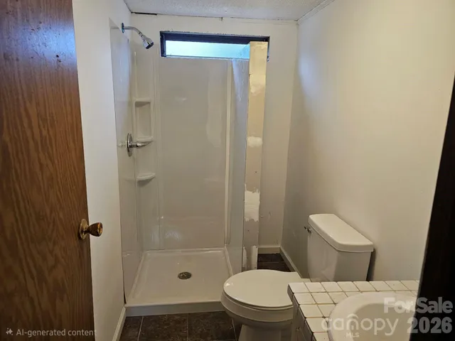 a white toilet sitting next to a bathroom sink