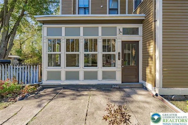 a front view of a house with a yard and seating space