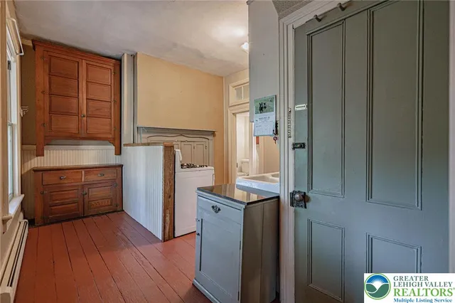 a kitchen with a stove cabinets and a refrigerator