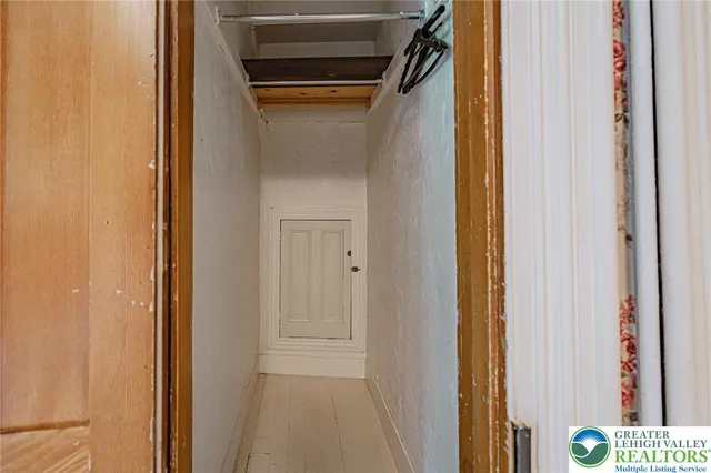 a view of a room with wooden floor and a window