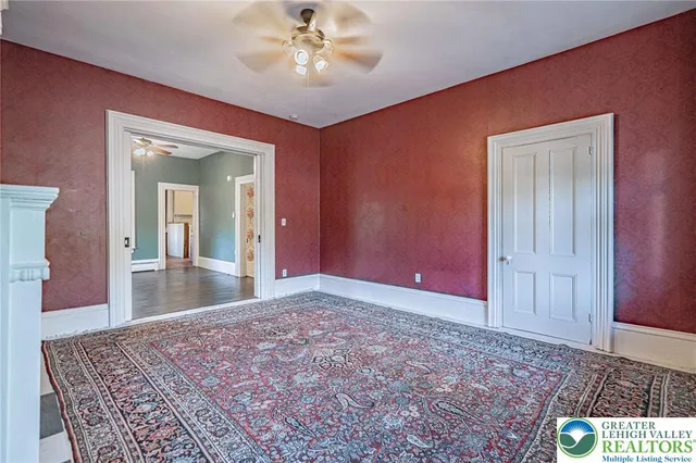 a view of front door with wooden floor and stairs