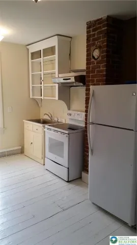 a kitchen with a refrigerator and a sink