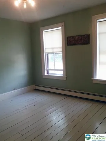 a bathroom with a toilet and a bath tub