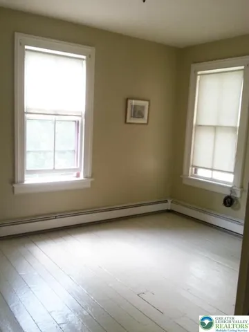 a kitchen with a stove top oven and cabinets