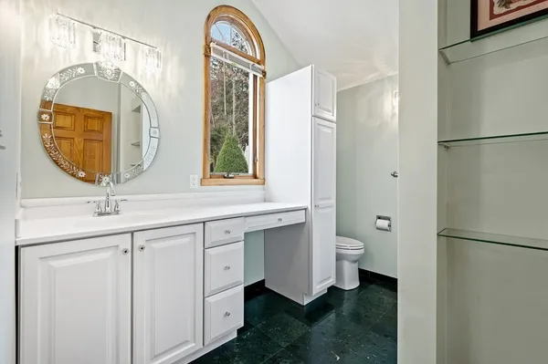 a bathroom with a sink a toilet and a shower curtain