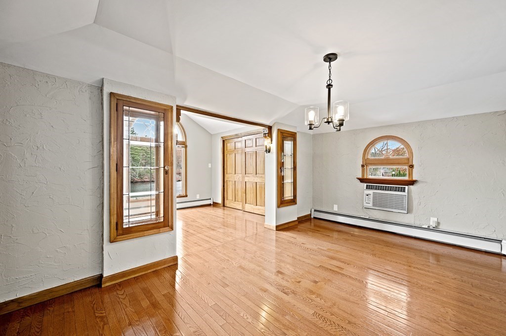 59 Cranberry Meadow Shore Road Charlton, MA 01507 - Photo 15 of 36 a view of an empty room with window and wooden floor
