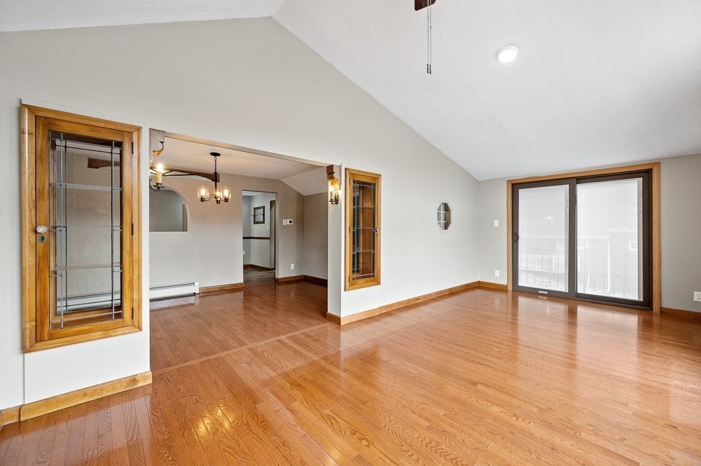 59 Cranberry Meadow Shore Road Charlton, MA 01507 - Photo 19 of 36 a view of an empty room with window and wooden floor