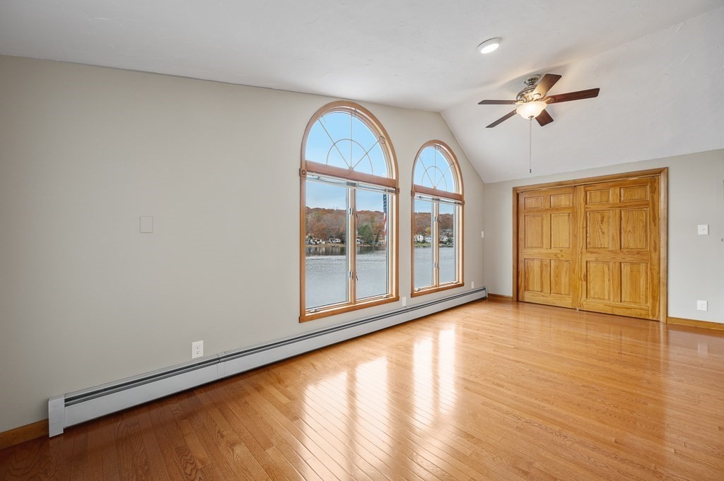 59 Cranberry Meadow Shore Road Charlton, MA 01507 - Photo 20 of 36 a view of empty room with wooden floor and fan