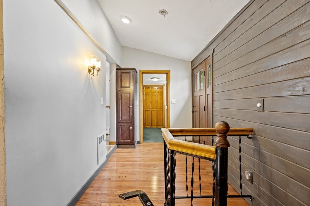 59 Cranberry Meadow Shore Road Charlton, MA 01507 - Photo 2 of 36 a view of a hallway with wooden floor and staircase