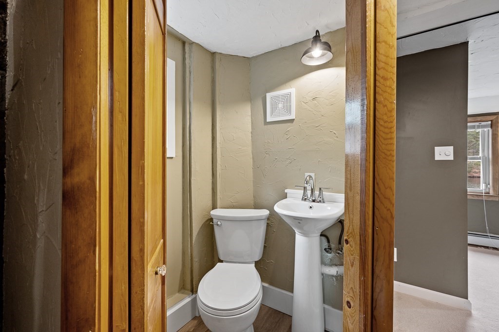 59 Cranberry Meadow Shore Road Charlton, MA 01507 - Photo 21 of 36 a bathroom with a sink mirror and toilet