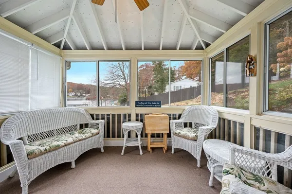 a white bed sitting in a room next to a window