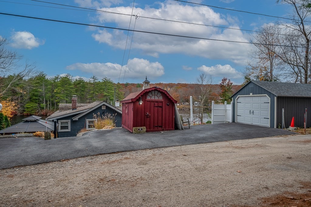 59 Cranberry Meadow Shore Road Charlton, MA 01507 - Photo 31 of 36 a view of a house with a yard and garage