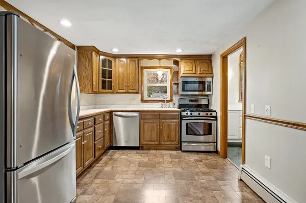 a kitchen with a stove a sink and a window