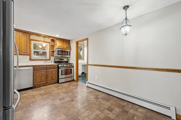 a refrigerator freezer sitting in a kitchen with stainless steel appliances granite countertop cabinets and a refrigerator