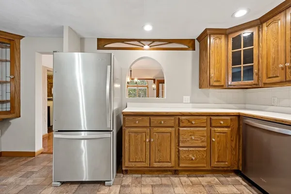 a kitchen with stainless steel appliances granite countertop a refrigerator and a sink