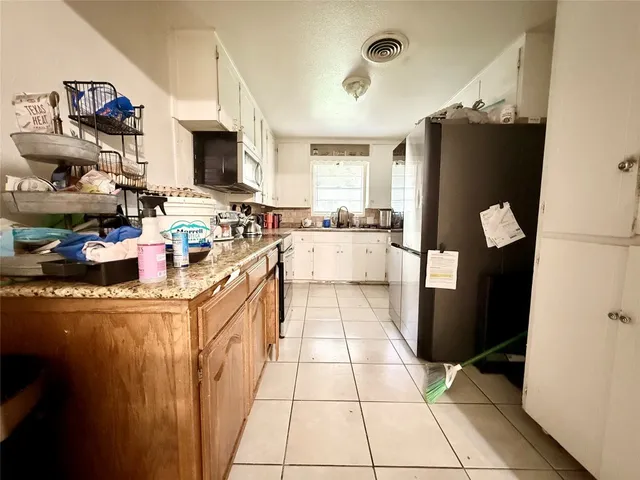 a kitchen with a sink stove and microwave