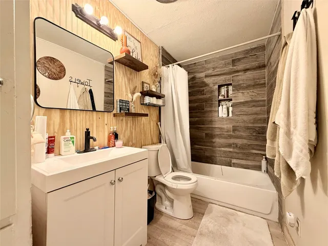 a bedroom with a bed a couch and a chandelier