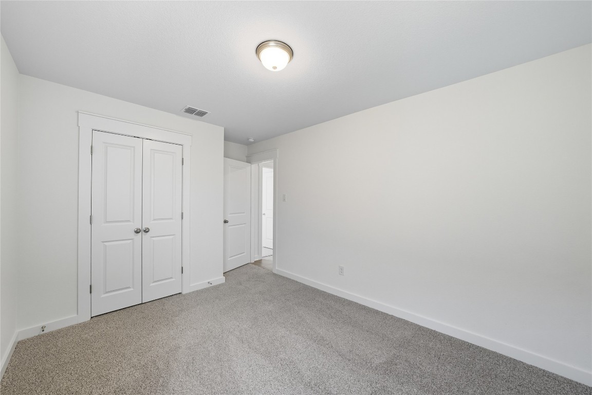 116 Crow Vly Drive Jarrell, TX 76537 - Photo 10 of 14 Unfurnished bedroom featuring carpet and a closet
