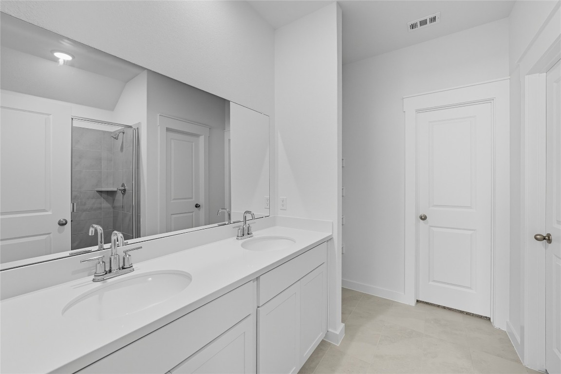 116 Crow Vly Drive Jarrell, TX 76537 - Photo 7 of 14 Full bath featuring a shower stall, double vanity, and light tile patterned floors