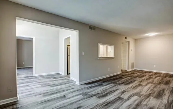a view of a room with wooden floor and window